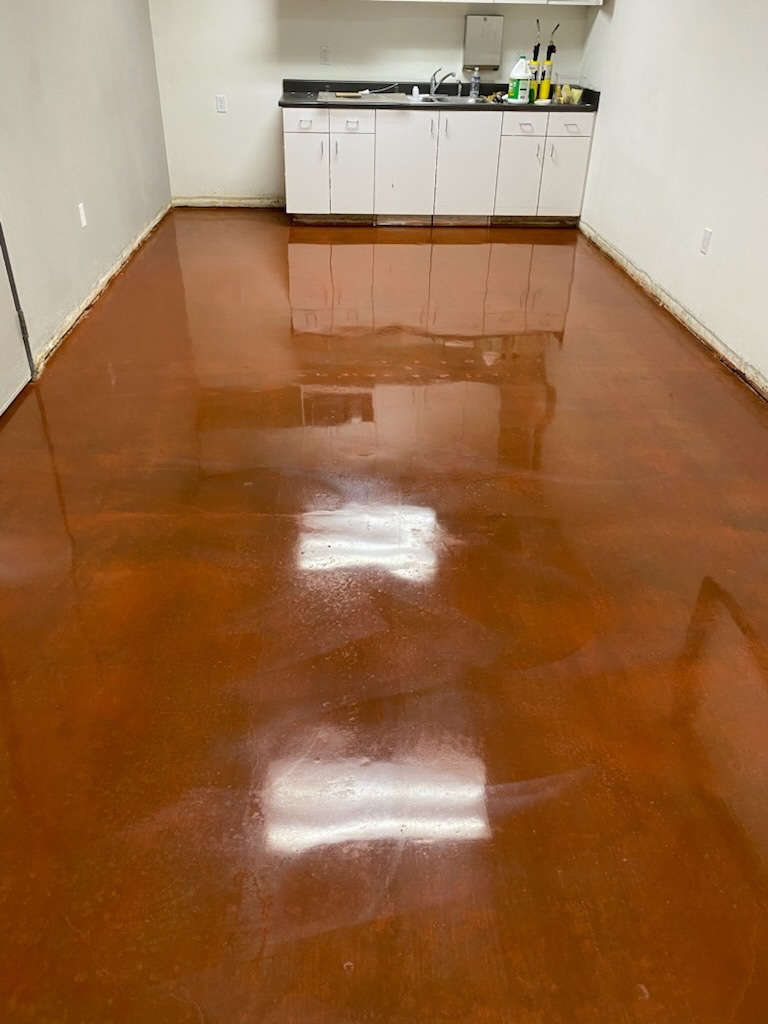 Stained concrete floor burnished to a high-gloss mirror finish