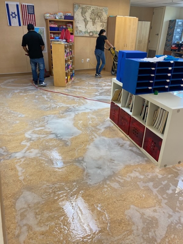 Floor strip-out in progress in a school classroom