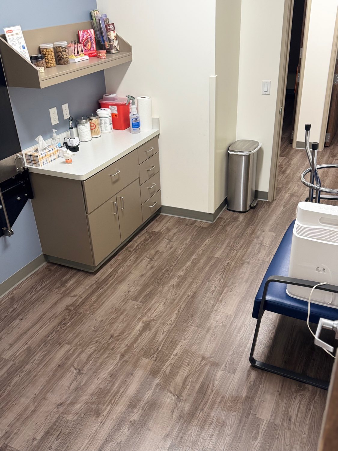 Veterinary exam room with clean wood-look plank flooring